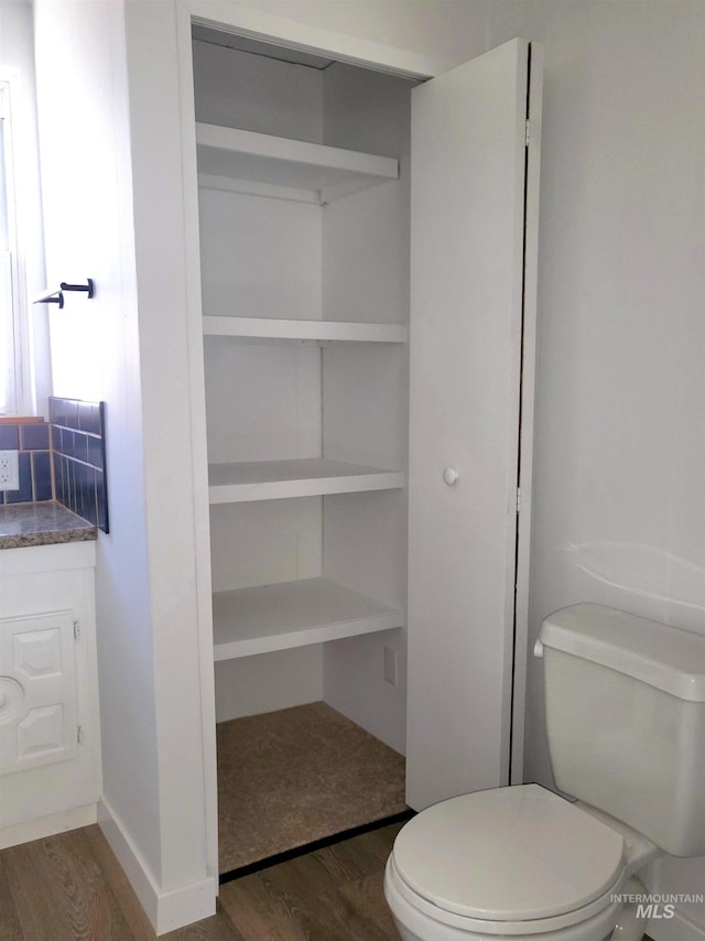 116 E 2nd St, Middleton, ID 83644 - half bathroom with wood finished floors, toilet, and vanity