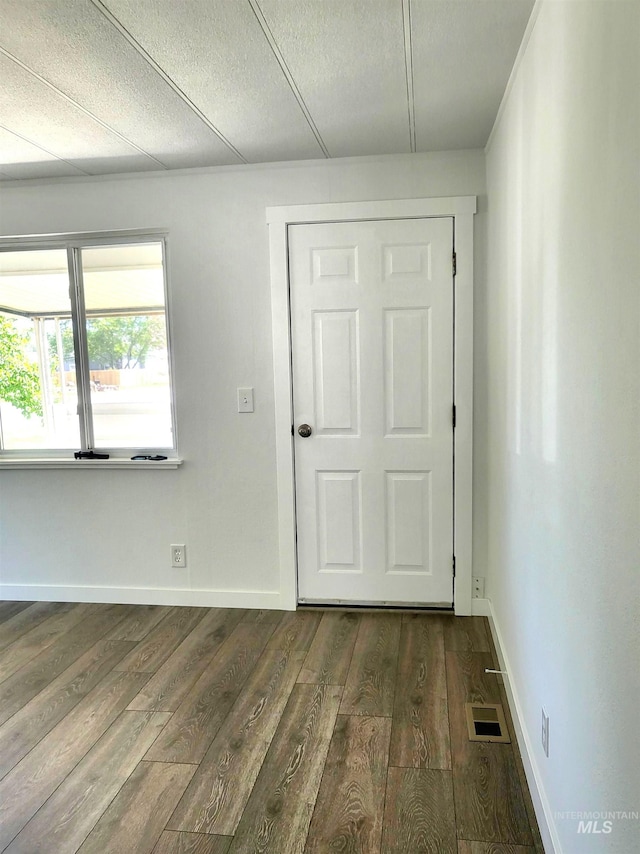 116 E 2nd St, Middleton, ID 83644 - spare room with dark wood-type flooring, baseboards, and a textured ceiling