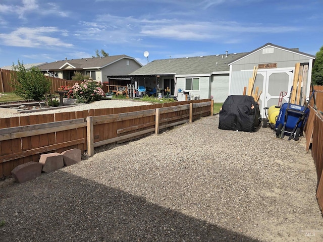 1451 Spurlock Ct, Twin Falls, ID 83301 - rear view of house featuring a shed, a fenced backyard, and a residential view