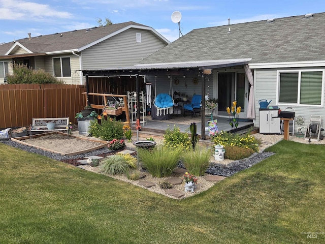 1451 Spurlock Ct, Twin Falls, ID 83301 - rear view of property with a wooden deck, roof with shingles, and a vegetable garden