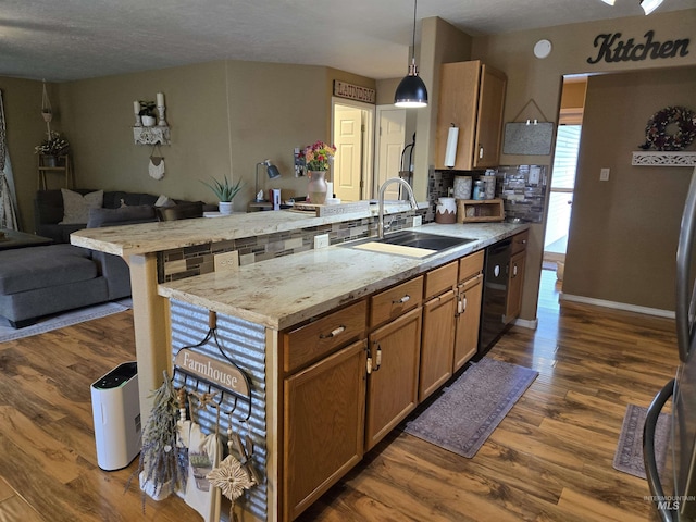 1451 Spurlock Ct, Twin Falls, ID 83301 - kitchen featuring a peninsula, black dishwasher, open floor plan, dark wood-style flooring, and tasteful backsplash