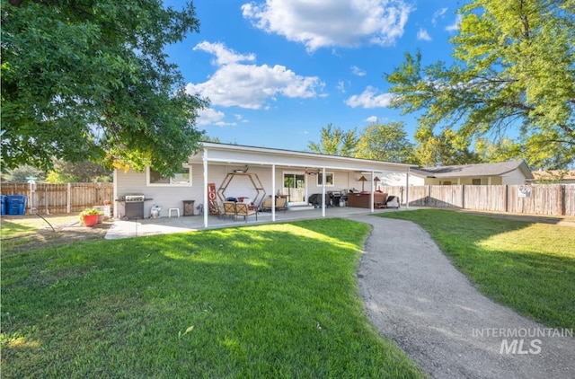 back of house with a patio, a lawn, a fenced backyard, and a jacuzzi