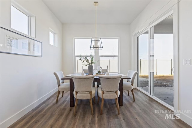 8820 E Snow Drop St, Nampa, ID 83687 - dining room featuring baseboards, dark wood-style flooring, and a notable chandelier
