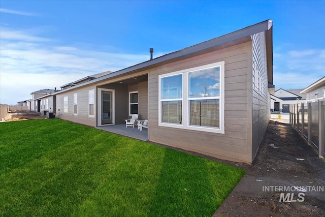 8820 E Snow Drop St, Nampa, ID 83687 - back of house featuring a yard, fence, central AC unit, and a patio area
