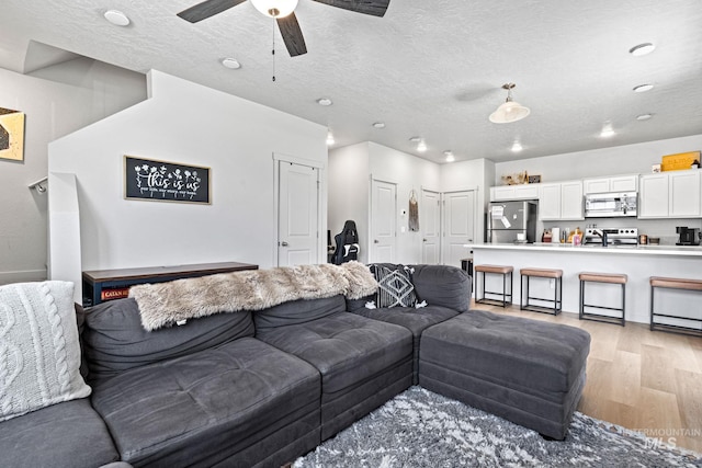 2312 E Spice Loop Unit 2, Nampa, ID 83687 - living area featuring light wood-style flooring, a textured ceiling, and a ceiling fan