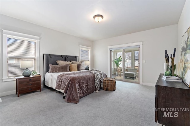 bedroom with access to outside, baseboards, and light colored carpet