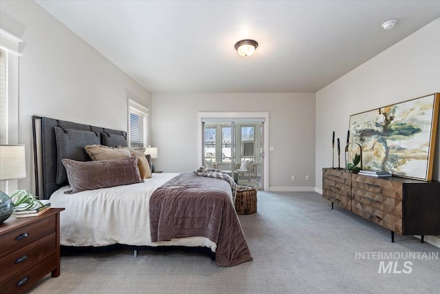 carpeted bedroom with access to outside and baseboards