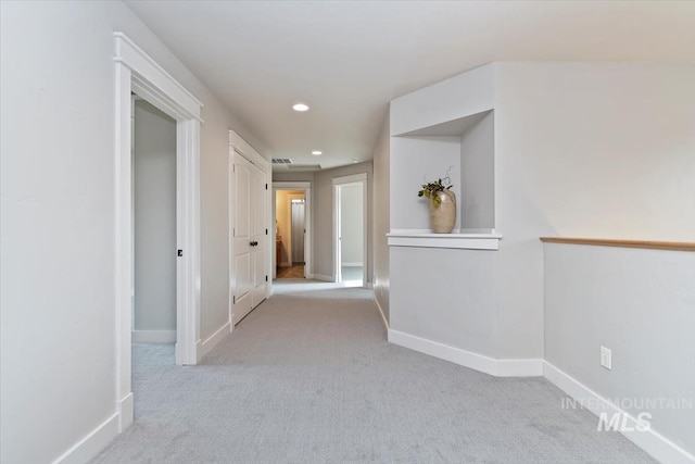 hall featuring recessed lighting, carpet, and baseboards