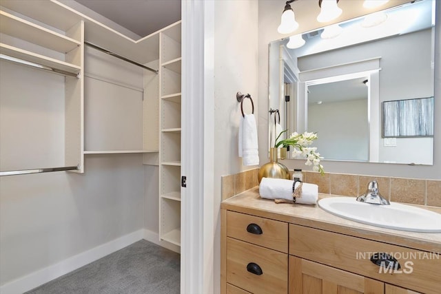 bathroom with baseboards and vanity