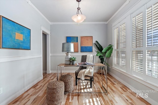 office area featuring ornamental molding, baseboards, and wood finished floors