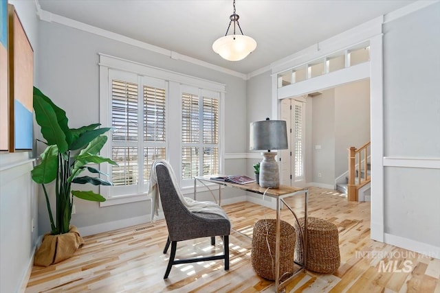 office space with crown molding, baseboards, and wood finished floors