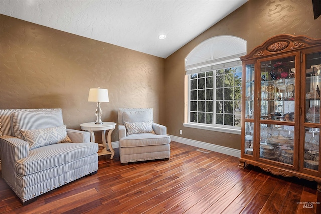 72 Pelican Dr, Rupert, ID 83350 - living area with baseboards, a textured wall, hardwood / wood-style flooring, a textured ceiling, and vaulted ceiling
