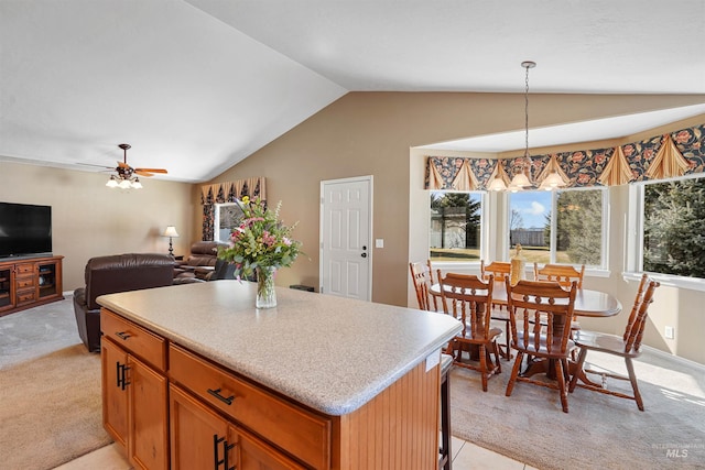 72 Pelican Dr, Rupert, ID 83350 - kitchen with hanging light fixtures, a center island, light countertops, light colored carpet, and lofted ceiling