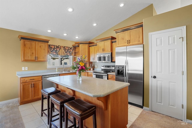 72 Pelican Dr, Rupert, ID 83350 - kitchen with vaulted ceiling, light countertops, a kitchen island, a kitchen bar, and stainless steel appliances