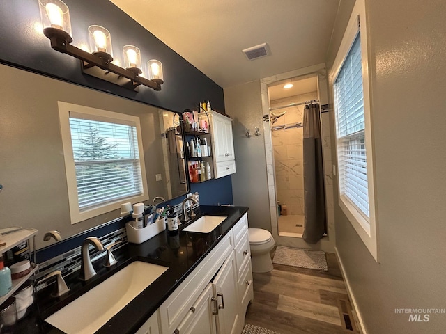 bathroom with vanity, hardwood / wood-style floors, curtained shower, and toilet