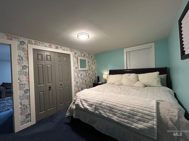 bedroom with a closet and dark colored carpet