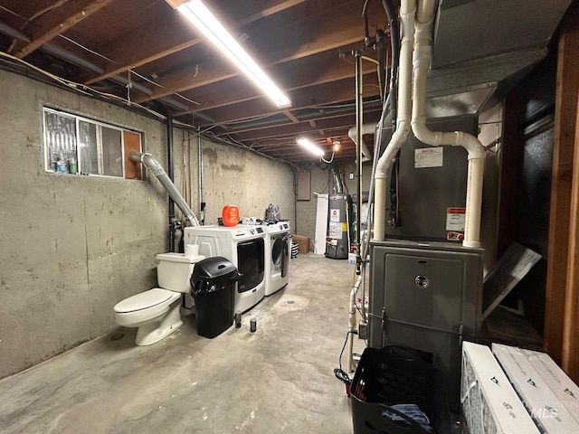 basement with washer and dryer, heating unit, and gas water heater