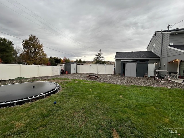 view of yard featuring an outdoor fire pit and a shed