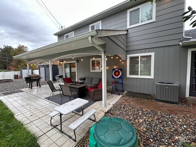 rear view of house featuring a patio, cooling unit, and an outdoor hangout area