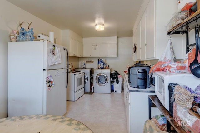 interior space with white cabinetry, light tile patterned flooring, washer / dryer, and white appliances