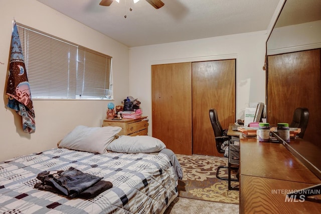 bedroom with ceiling fan and light colored carpet