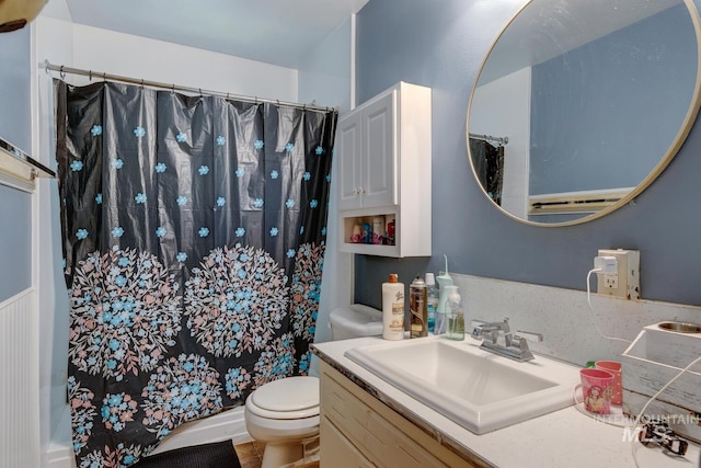 full bathroom featuring toilet, vanity, and shower / tub combo with curtain