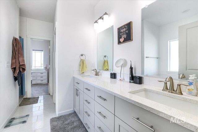209 W 13th Ave, Jerome, ID 83338 - bathroom with double vanity, baseboards, and tile patterned flooring