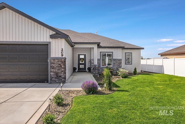 209 W 13th Ave, Jerome, ID 83338 - view of front of property featuring stone siding, a garage, board and batten siding, and a shingled roof