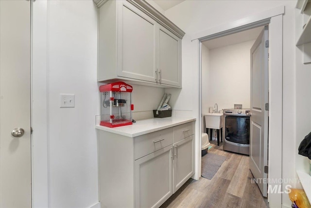 209 W 13th Ave, Jerome, ID 83338 - washroom featuring washer / dryer and light wood-style flooring