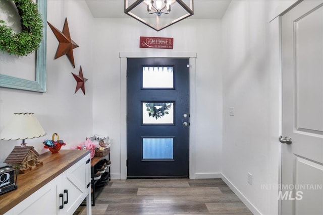 209 W 13th Ave, Jerome, ID 83338 - foyer featuring wood finished floors, a chandelier, and baseboards