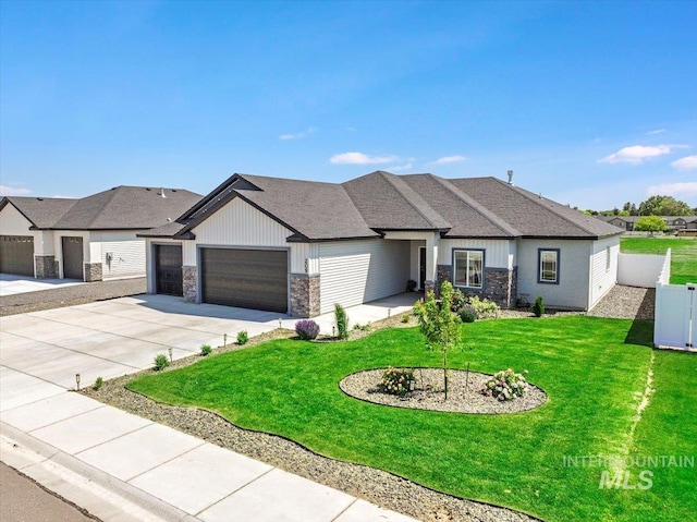 209 W 13th Ave, Jerome, ID 83338 - view of front of property featuring stone siding, a garage, driveway, roof with shingles, and board and batten siding