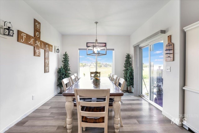 209 W 13th Ave, Jerome, ID 83338 - dining room featuring a chandelier, dark wood-type flooring, and baseboards