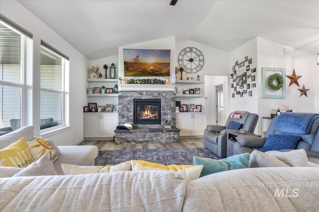 209 W 13th Ave, Jerome, ID 83338 - living area featuring lofted ceiling, wood finished floors, and a stone fireplace