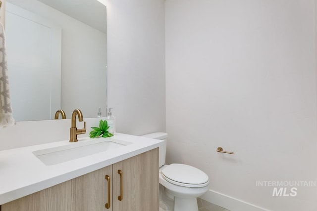 bathroom featuring vanity, toilet, and tile patterned floors