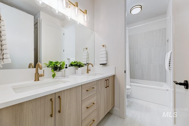 full bathroom featuring vanity, shower / bath combo, and toilet