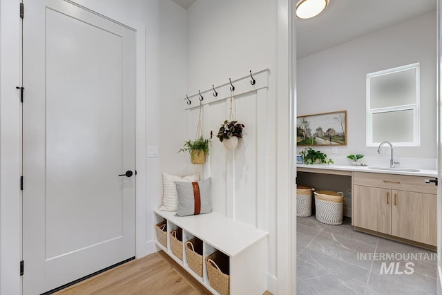 mudroom featuring sink and light hardwood / wood-style flooring