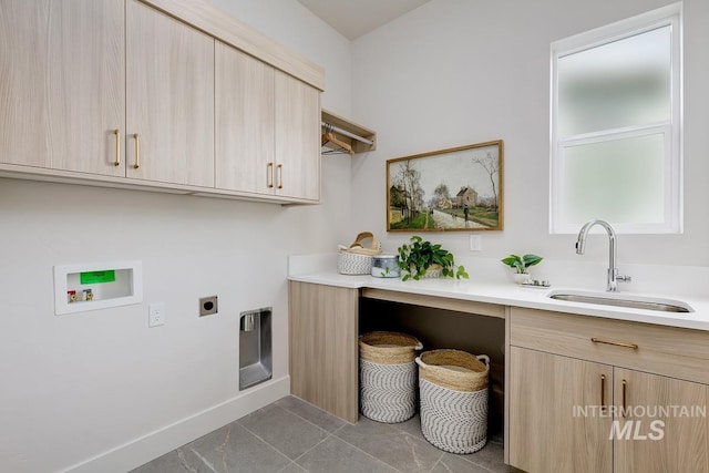 laundry room featuring tile patterned flooring, hookup for a washing machine, hookup for an electric dryer, sink, and cabinets