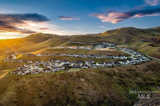 aerial view at dusk featuring a mountain view