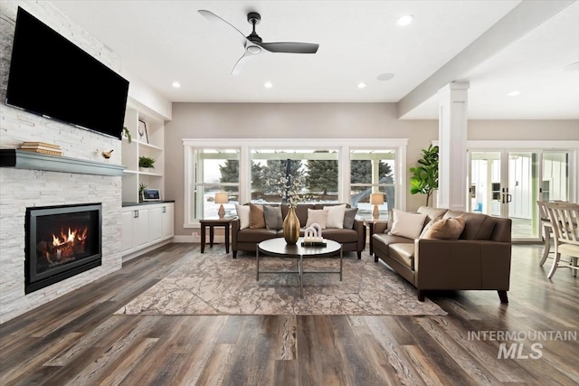 living area with a ceiling fan, recessed lighting, dark wood-style flooring, and a fireplace