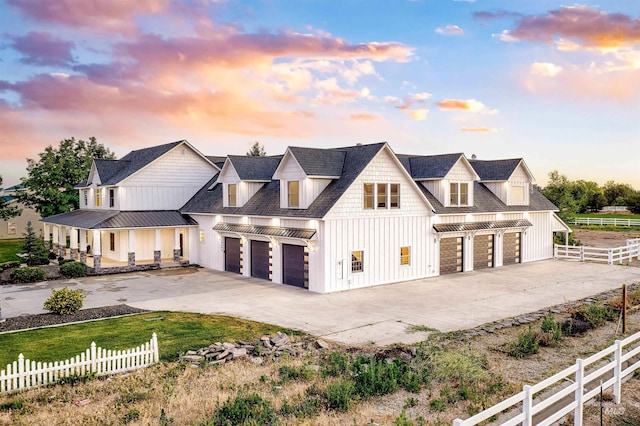 modern farmhouse with driveway, metal roof, a standing seam roof, fence, and board and batten siding