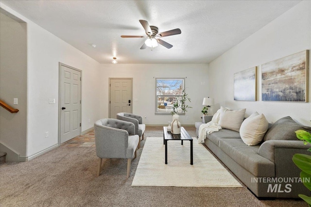 carpeted living room with ceiling fan