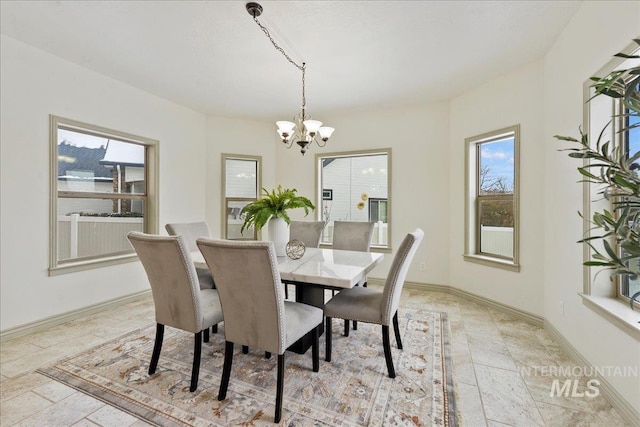 dining space featuring a notable chandelier