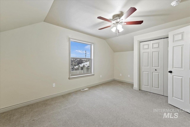 additional living space with lofted ceiling, light carpet, and ceiling fan