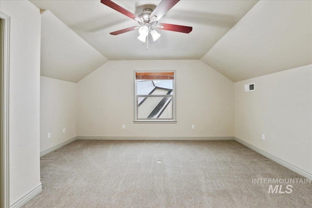 bonus room with lofted ceiling, light colored carpet, and ceiling fan