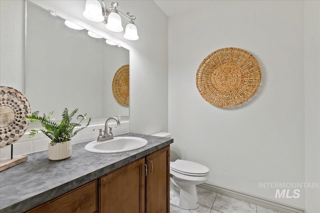 bathroom featuring vanity, tile patterned floors, and toilet