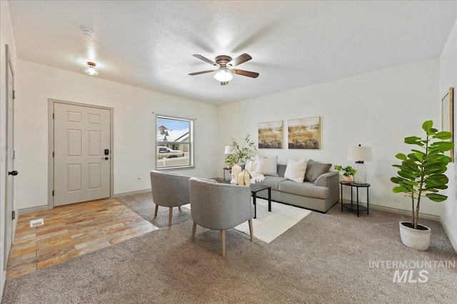 carpeted living room featuring ceiling fan