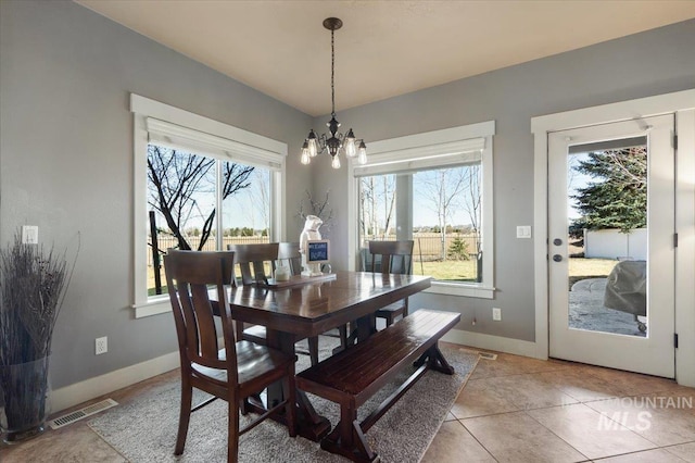 dining area with an inviting chandelier, baseboards, visible vents, and a wealth of natural light