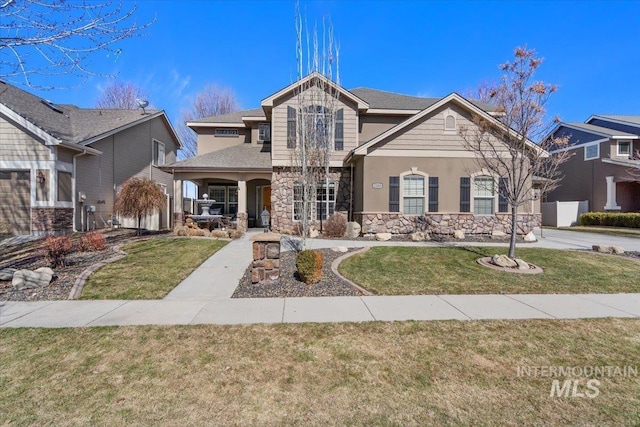 view of front of house with a front lawn and stone siding