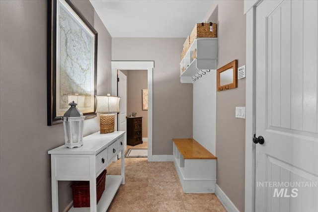 mudroom featuring light tile patterned flooring and baseboards