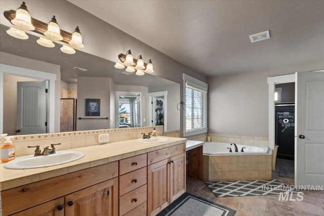 bathroom with visible vents, a stall shower, a sink, double vanity, and a bath